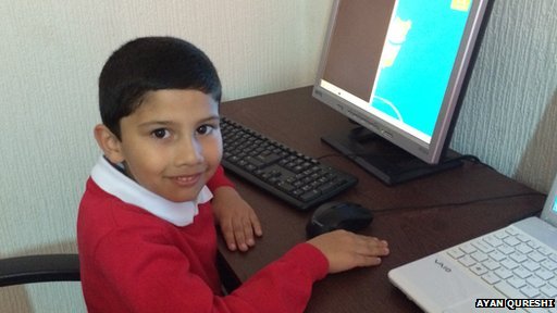 5-year-old kid sitting at his computer desk.